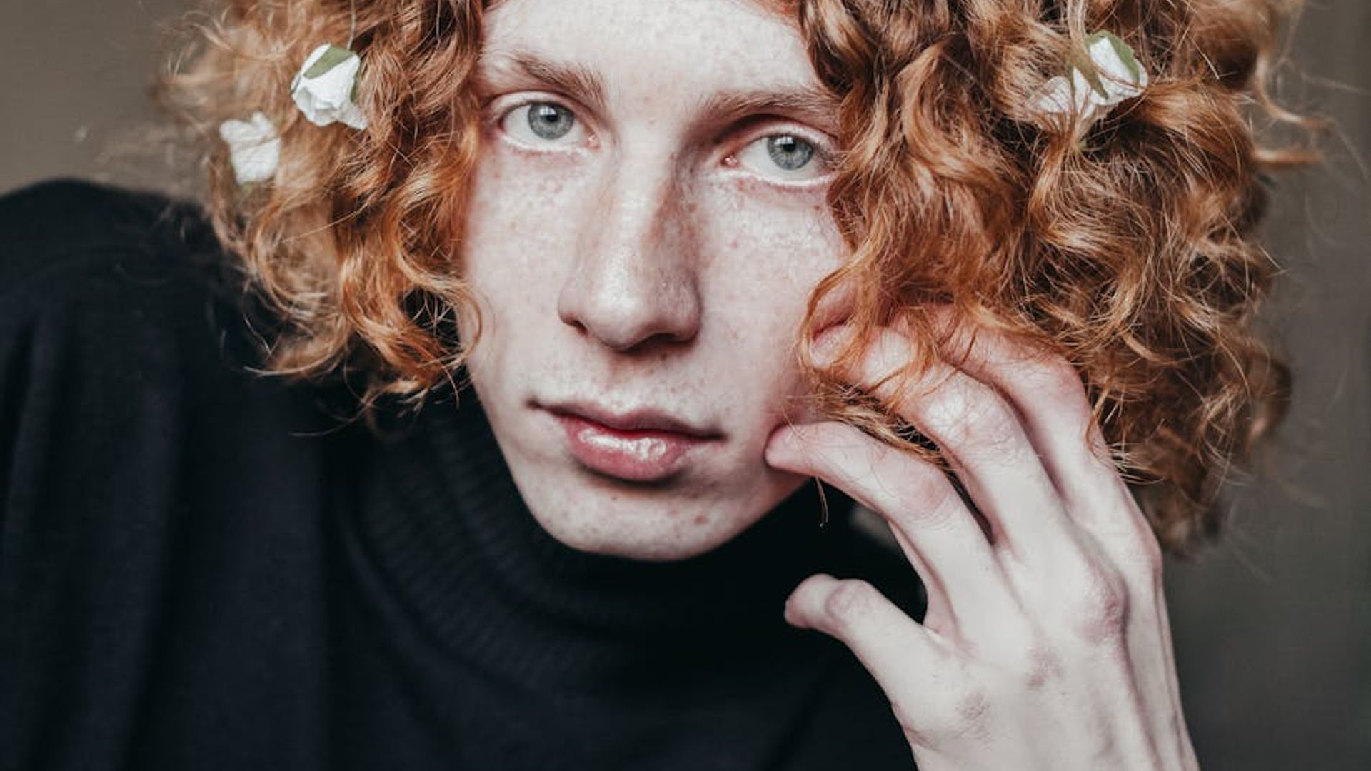 Person looking at the sunset with clear calm expression.